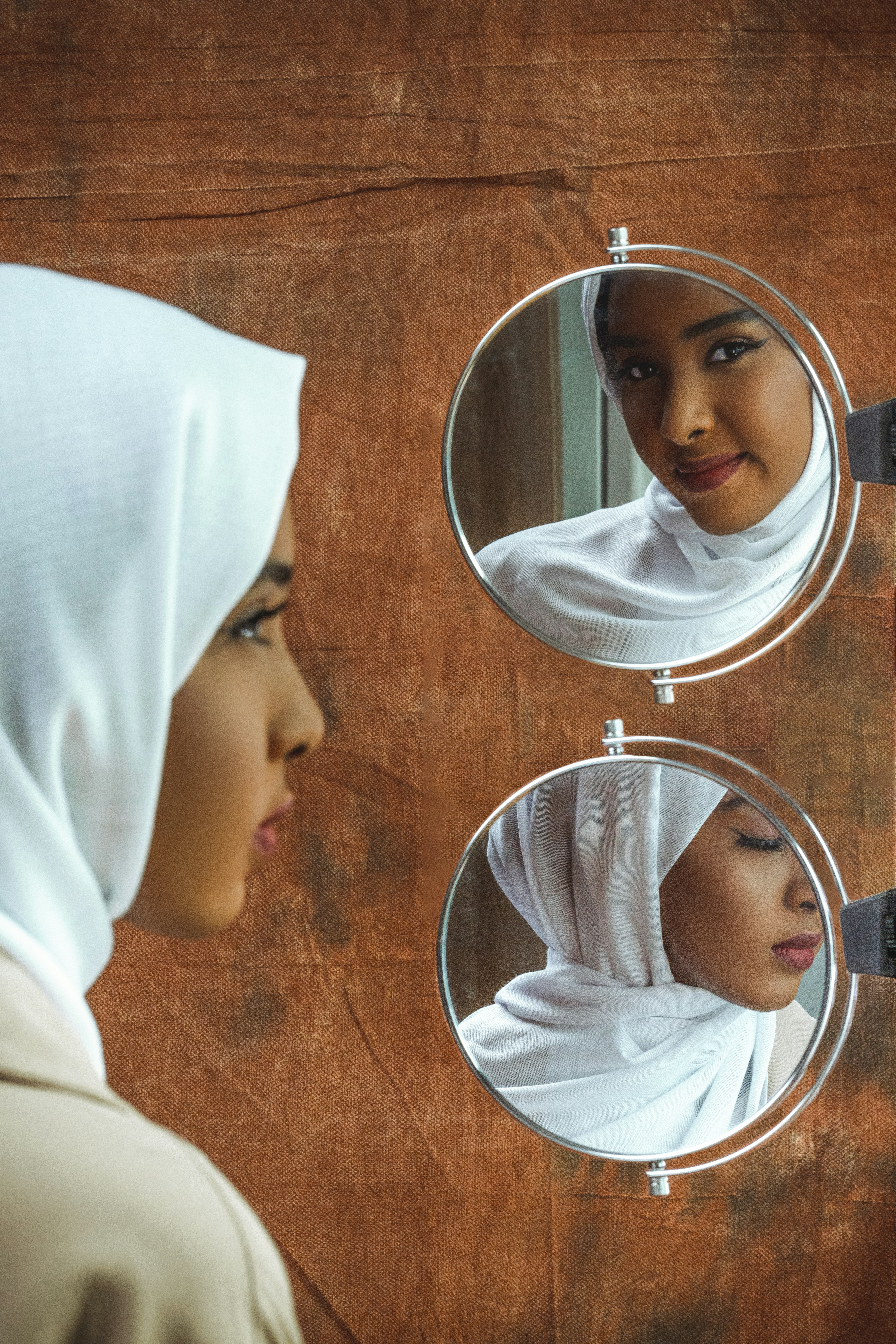 woman in white hijab taking selfie
